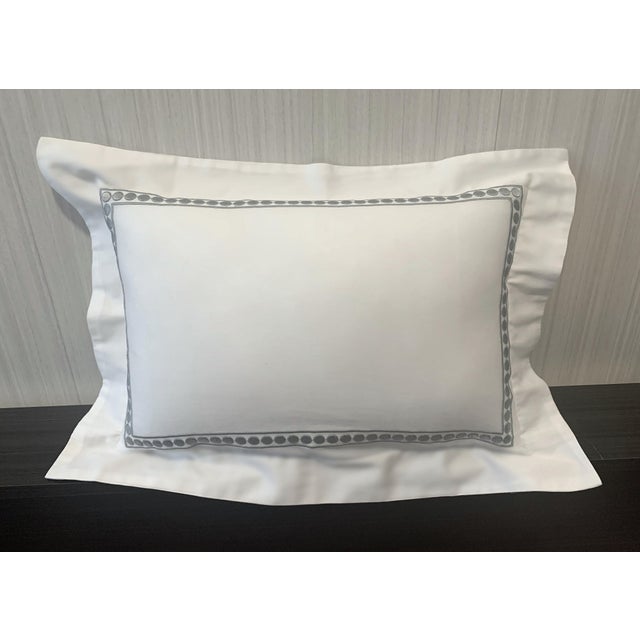 Adorable and sweet looking white lumbar pillow with embroidered border inset. Enclosed zipper on back of pillow. Border...