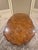 This is a beautiful vintage/antique-style carved wood dining table with an exceptional burl wood and marquetry-style top....