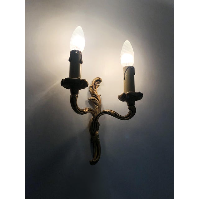Antique Pair of Double-Light Bronze Wall Sconces Pair of bronze wall sconces, each topped with a wooden candle holder. In...