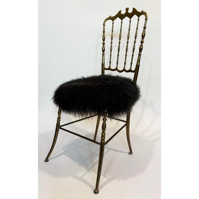 1950's solid brass Chiavari chair from Italy. Seat has been updated with New Zealand black curly sheep skin covering....