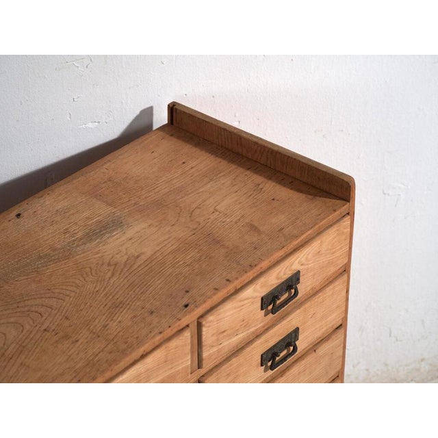 Antique Japanese multi-drawer cabinet (hikidashi-dansu) crafted in Japanese ash and dating to the late Taishō to early...