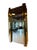 A striking vintage wall mirror featuring dramatic sculptural brass columns on each side, capped with contrasting chrome...