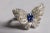 A fun butterfly motif ring featuring a center, round faceted blue sapphire and round, brilliant cut diamonds comprising...