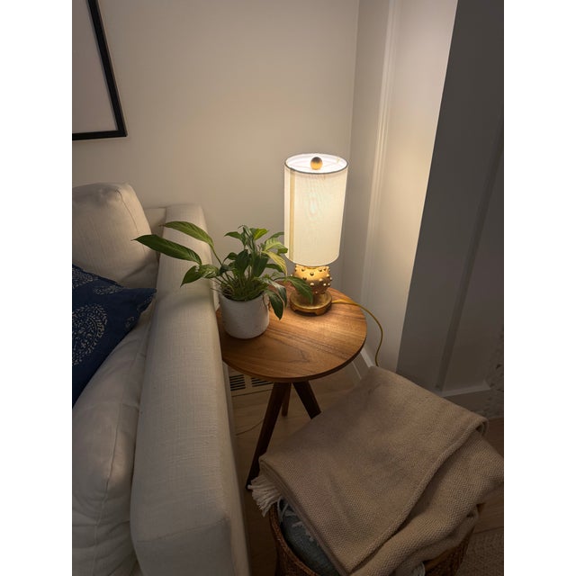 Featuring a hand-applied gold leaf finish, this spherical "stud" base offers a tactile, sculptural quality that catches...