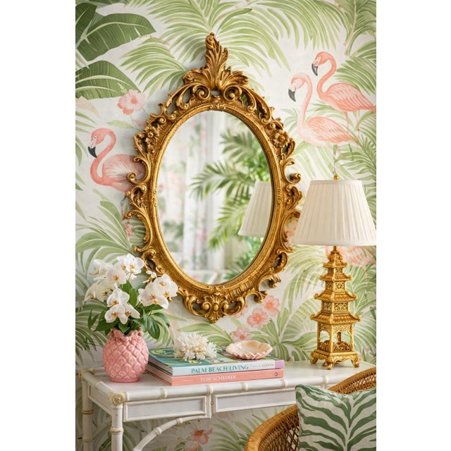 Elevate your space with this vintage gold wall mirror, crafted in the Syroco wood style and featuring an elaborate...
