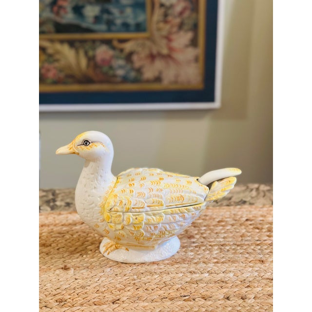 This is a charming vintage ceramic duck-shaped covered tureen or lidded serving dish, finished in glossy white with hand-...