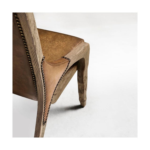 The side chair with nailhead trim combines classic craftsmanship with a relaxed, refined look. Its warm, distressed brown...