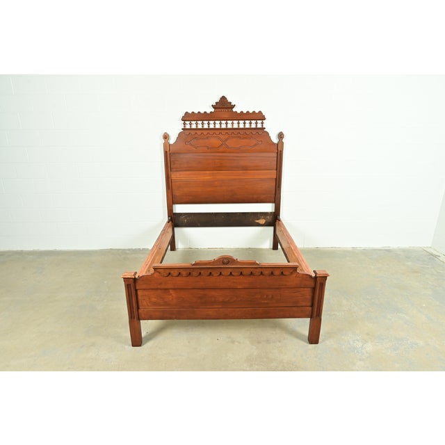 A gorgeous monumental antique Eastlake Victorian carved walnut full size bed frame In the manner of Herter Brothers USA,...