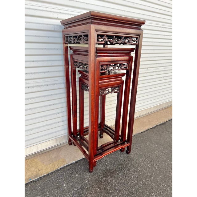 Vintage Set of Chinese rosewood nesting tables each one having a pierced apron with song birds and cherry blossoms....