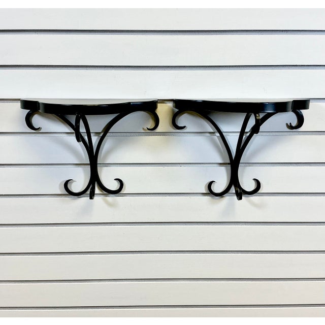 This pair of vintage wall bracket shelves have such a pretty shape. The tole painted metal tops are in a half clover shape...