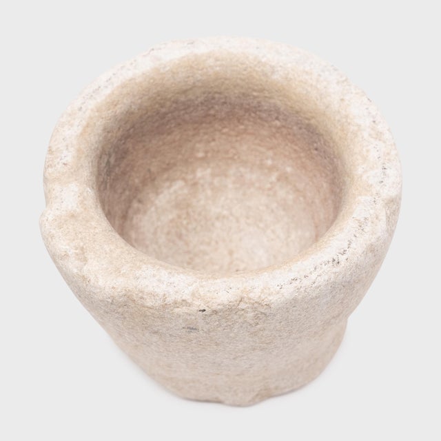 Hand-carved from a single block of marble, this original stone vessel is an antique Chinese mortar once used to grind...