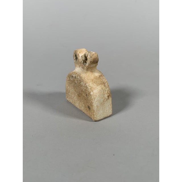 Bell-shaped "eye" idol. Tell Brak, Middle East. It has a bell-shaped body surmounted by two pierced eyes. Sculpture in...