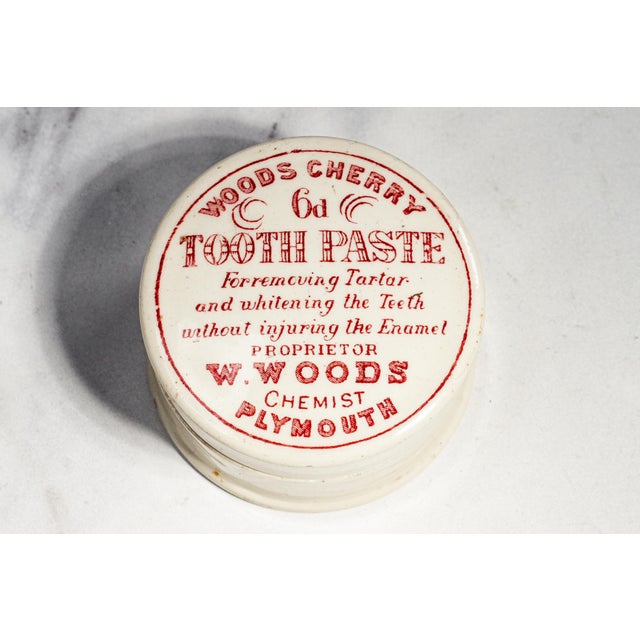 A charming survivor of Victorian advertising history, this antique Woods Cherry Tooth Paste lidded pot is a wonderful...
