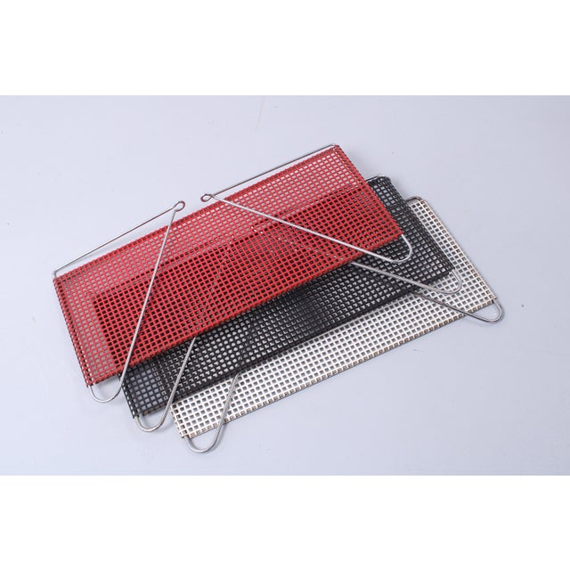 Characteristic and very decorative small shelving units from the Netherlands, in the manner of Pilastro / Mategot....