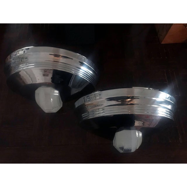 A pair of wall Etruscan sconces designed and manufactured by Karl Springer, circa 1970s. Made of chromed steel with opaque...