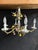 A wonderfully ornate vintage six-light chandelier combining richly detailed porcelain floral decoration with scrolling...