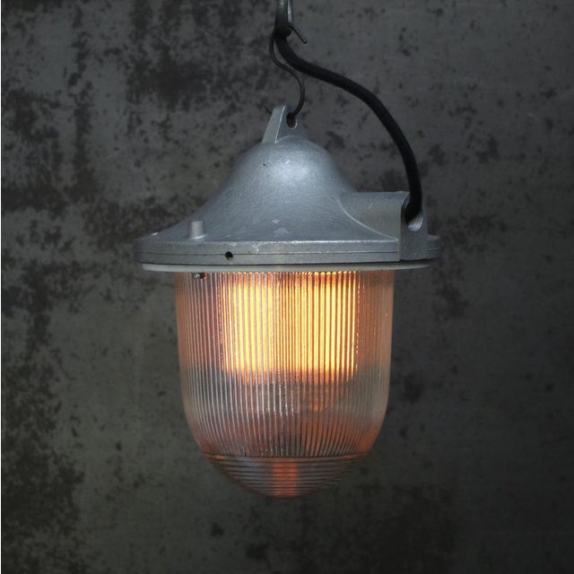 Grey pendant lamp with clear striped glass Cast aluminium top E27 / E26 Up to 250V (Europe/UK Standard).The wiring of this...