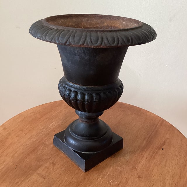 This Vintage Patinated Cast Iron Campagna Style Fluted Rim Square Base Garden Urn is a charming addition to any patio....