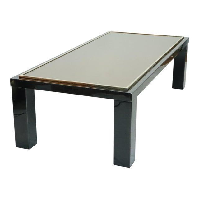 Vintage rectangular coffee table with a sleek design, featuring a black-lacquered metal frame and a thick smoked glass...