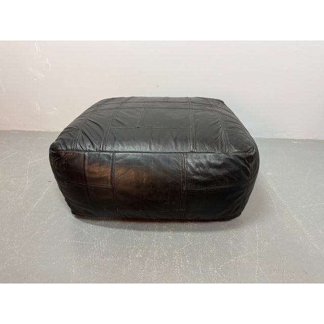 Substantial and heavy patchwork leather pouf, attributed to De Sede. Crafted from high-quality leather panels stitched in...
