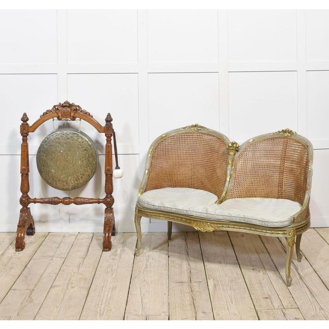 Late 19th century painted and parcel gilt caned canape settee, the double caned back of twin arched form comprised of...