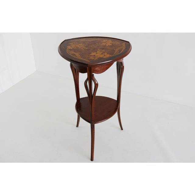 This elegant Art Nouveau side table, signed by Louis Majorelle and made in France circa 1900, is a fine example of the...