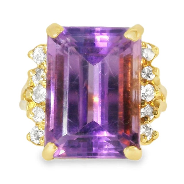 This antique 14K yellow gold diamond and amethyst statement ring is a captivating blend of elegance and bold design. The...