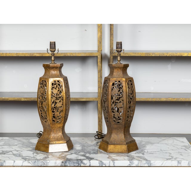 A pair of vintage Asian carved table lamps from the mid 20th century with pierced openwork foliage and floral motifs,...
