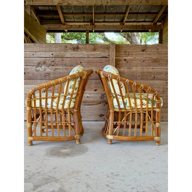 A charming pair of vintage Henry Link pencil rattan lounge chairs featuring the iconic sculptural frame and original...