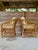 A charming pair of vintage Henry Link pencil rattan lounge chairs featuring the iconic sculptural frame and original...