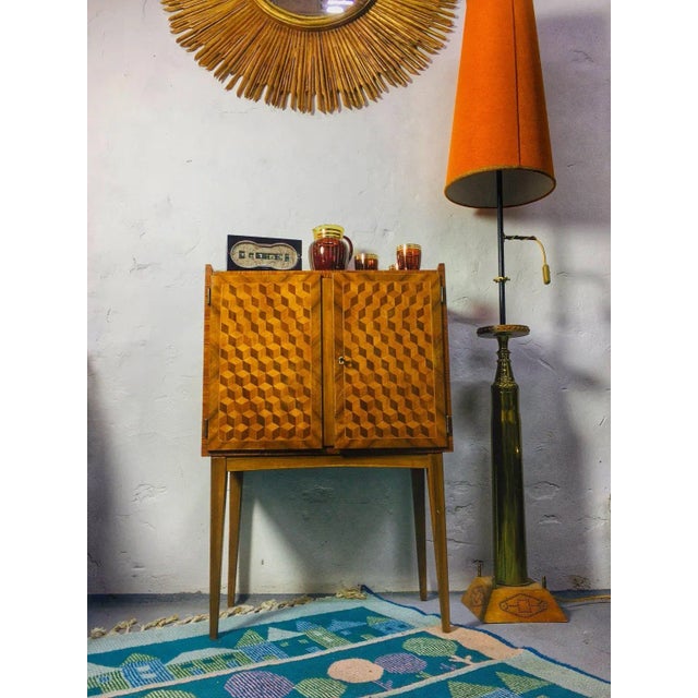 Applied art rug from the 1960s.The colorful alternation of houses and forest trees gives it its cheerful pattern. It is...