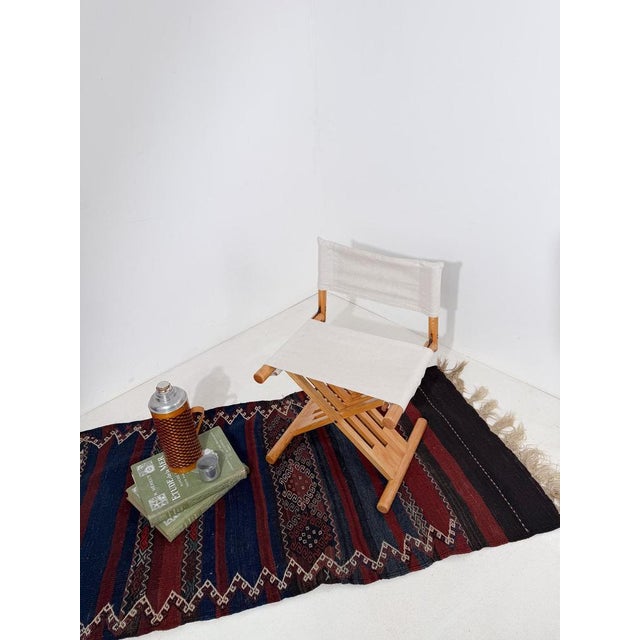 Distinctive Mid-Century Modern folding chair, a refined interpretation of the iconic Italian Renaissance Savonarola chair....