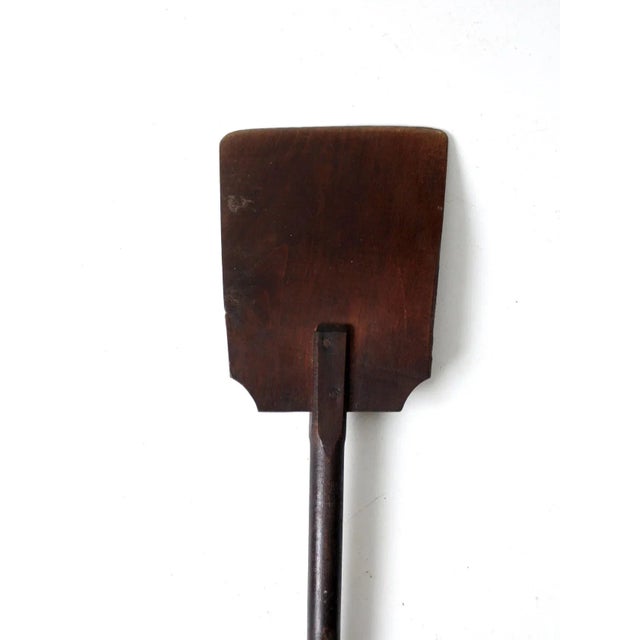 This is an antique primitive wood shovel. Beautiful tone to the wood with a thin tapered square head blade.