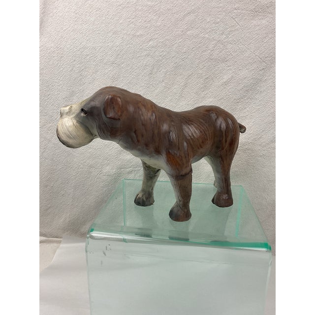 Leather clad bulldog figures. This guy has glass eyes. Medium brown in color with whitish face
