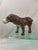 Leather clad bulldog figures. This guy has glass eyes. Medium brown in color with whitish face