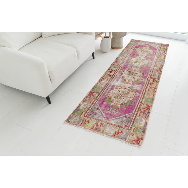 This is a vintage Turkish Oushak rug from the Mid 20th Century. The piece was hand-knotted.