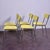 This beautiful set of 5 chairs features a bright pastel yellow Formica seat and backrest, with an elegant dark edge...