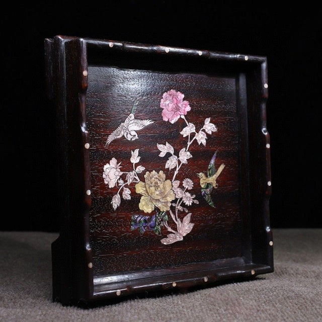 This is an exquisitely crafted square wooden tray featuring intricate mother-of-pearl (nacre) inlay work. Crafted from a...