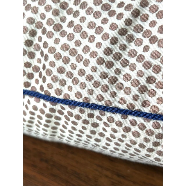 Brown and white polka dot pillow with navy blue trim along all the edges. Perfect condition. 17" x 17" x 5"