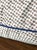 Brown and white polka dot pillow with navy blue trim along all the edges. Perfect condition. 17" x 17" x 5"