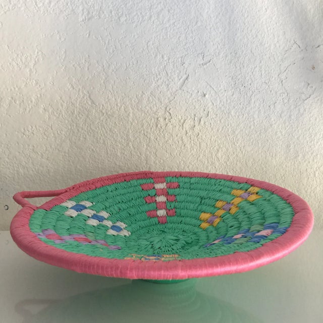 A beautiful grain basket woven in modern colors with modern materials. It’s shape was used in previous forms for grinding...