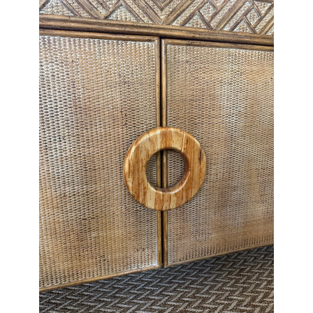Faux bamboo and woven rattan cabinet with white washed/ aged finish. Love the circular wood ring hardware. Bamboo fretwork...