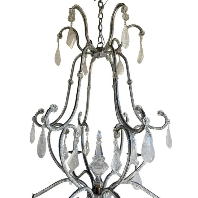 An exceptionally elegant French chandelier with six candle-form lights and a delicately scrolled iron frame entirely hand-...
