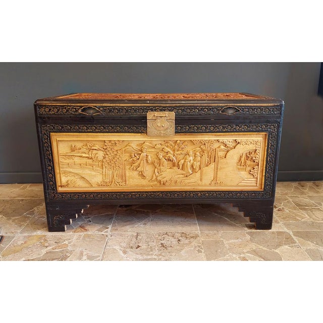 Inlaid camphor wood chest trunk produced in China in the mid-20th century. The scenes depicted are classic examples of...