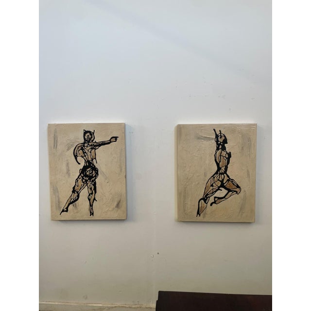 Pair of textured paintings depicting stylized human figures, created with lacquer paint and textured technique on a panel...