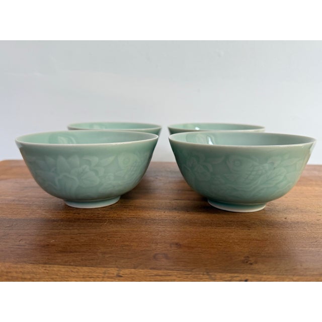A beautiful set of four Chinese celadon rice bowls with a subtle lotus and carp motif. Classic and timeless pieces. Most...
