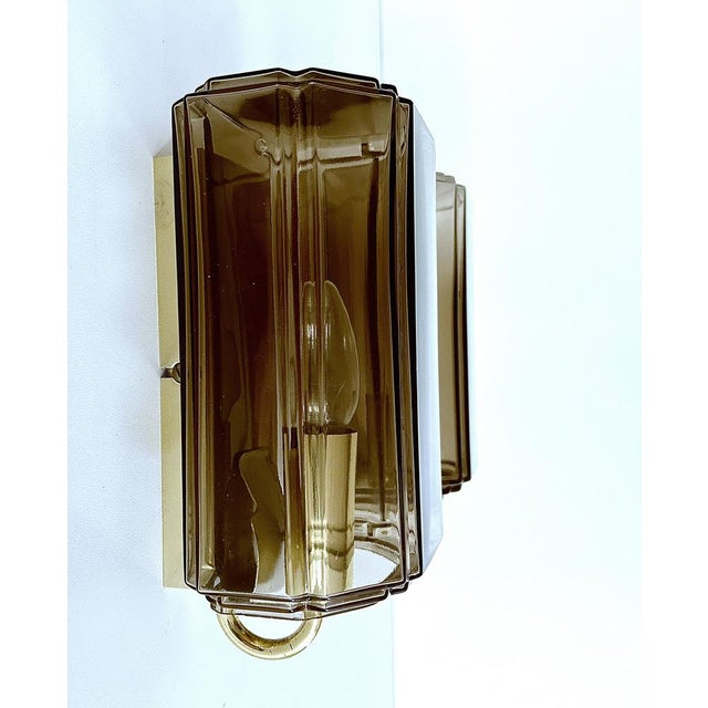 Pair of Vintage Limburg wall Lights featuring smoked glass shades mounted on a brass rectangular frame, original 1970s...