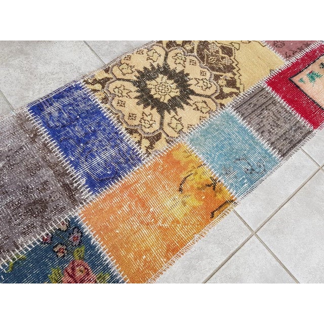 This is a vintage Turkish Oushak rug from the Mid 20th Century. The piece was hand-knotted.