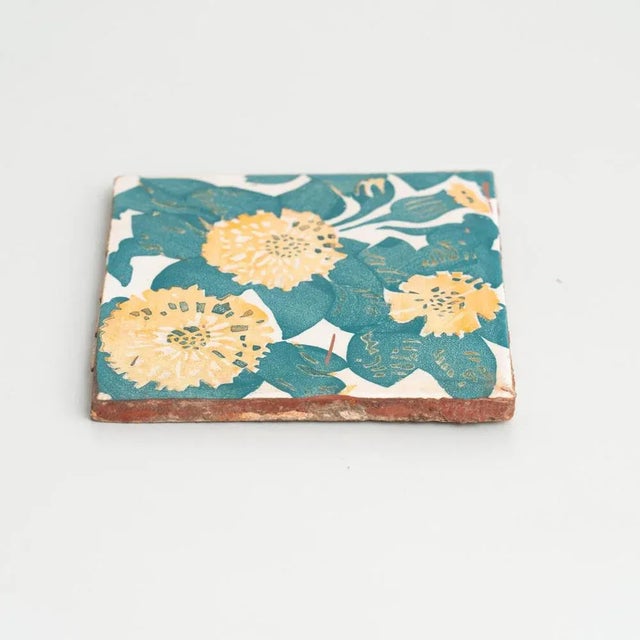 Decorative ceramic tile by Antoni Gaudi, inspired by the marigold and dianthus motifs on the decorative ceramic tiles he...