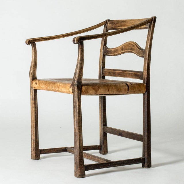 Beautiful Swedish Grace armchair by Carl Malmsten, made from oak with a leather seat. Clean lines, statuesque expression....